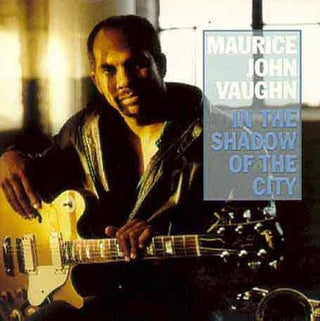 the album cover for Maurice Vaughn John - In the Shadow of the City