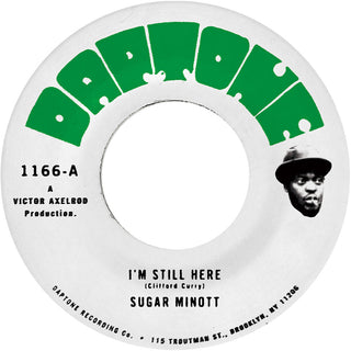 the album cover for Sugar Minott - I'm Still Here B/W I'm Still Here - Version